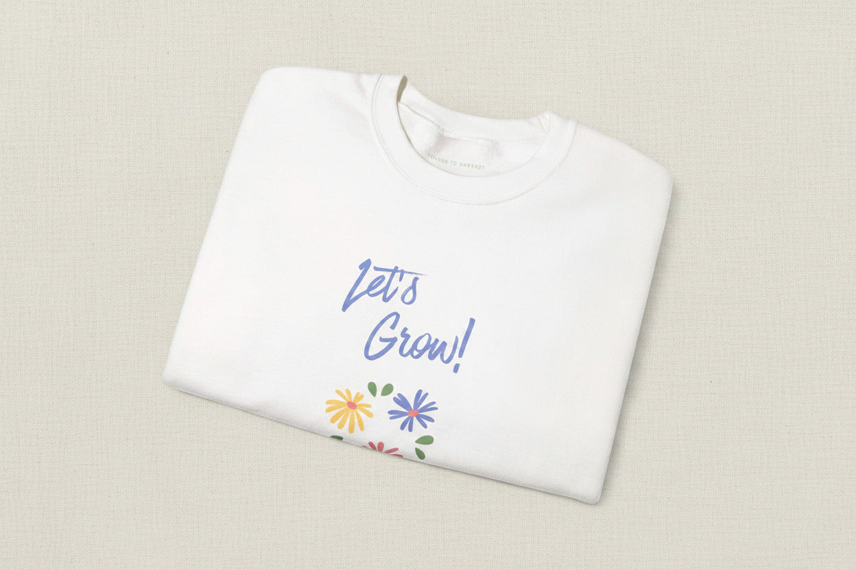 White shirt with 'Let's Grow!' text and floral designs on a white background
