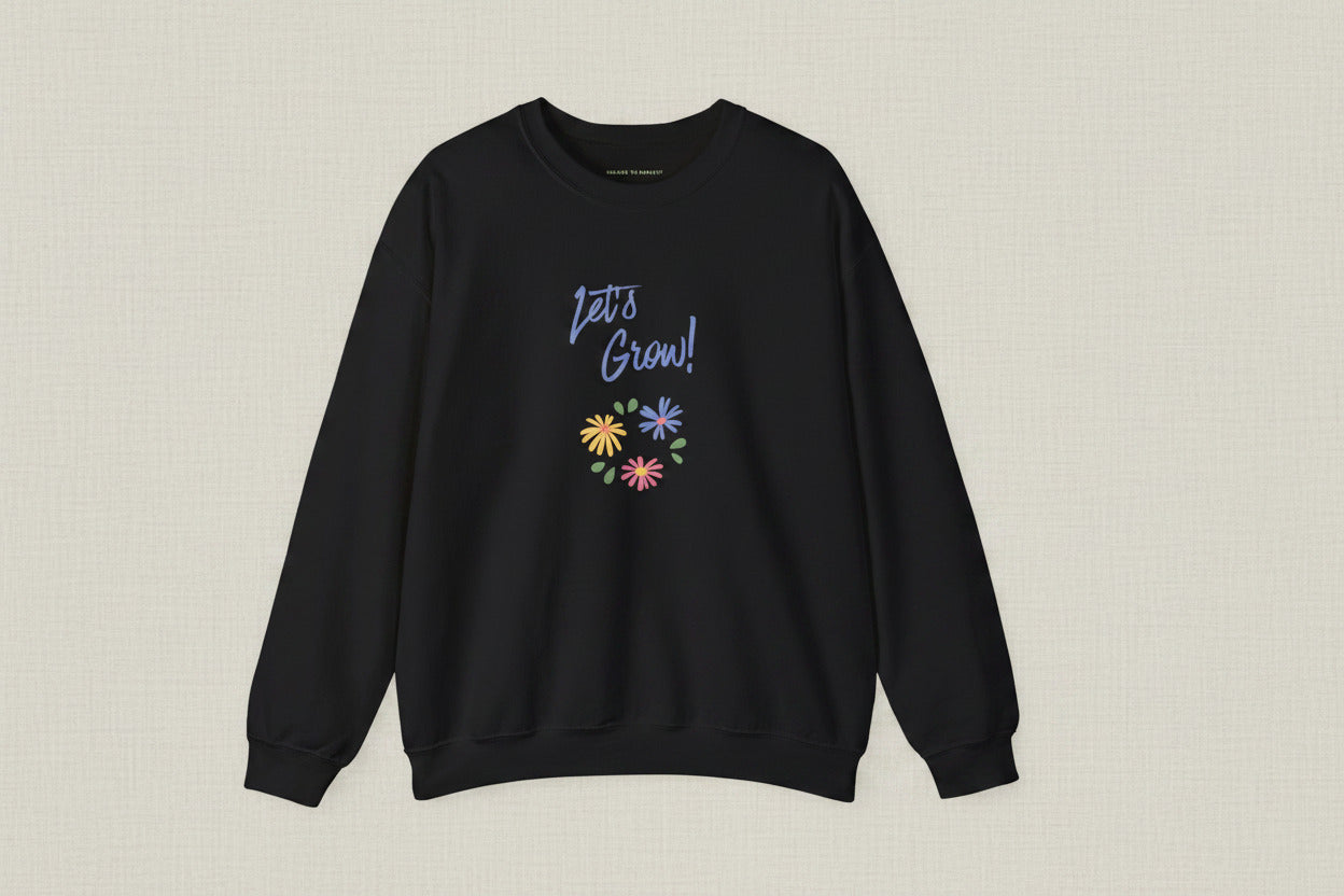 Black sweatshirt with 'Let's Grow!' text and colorful flowers on a white background