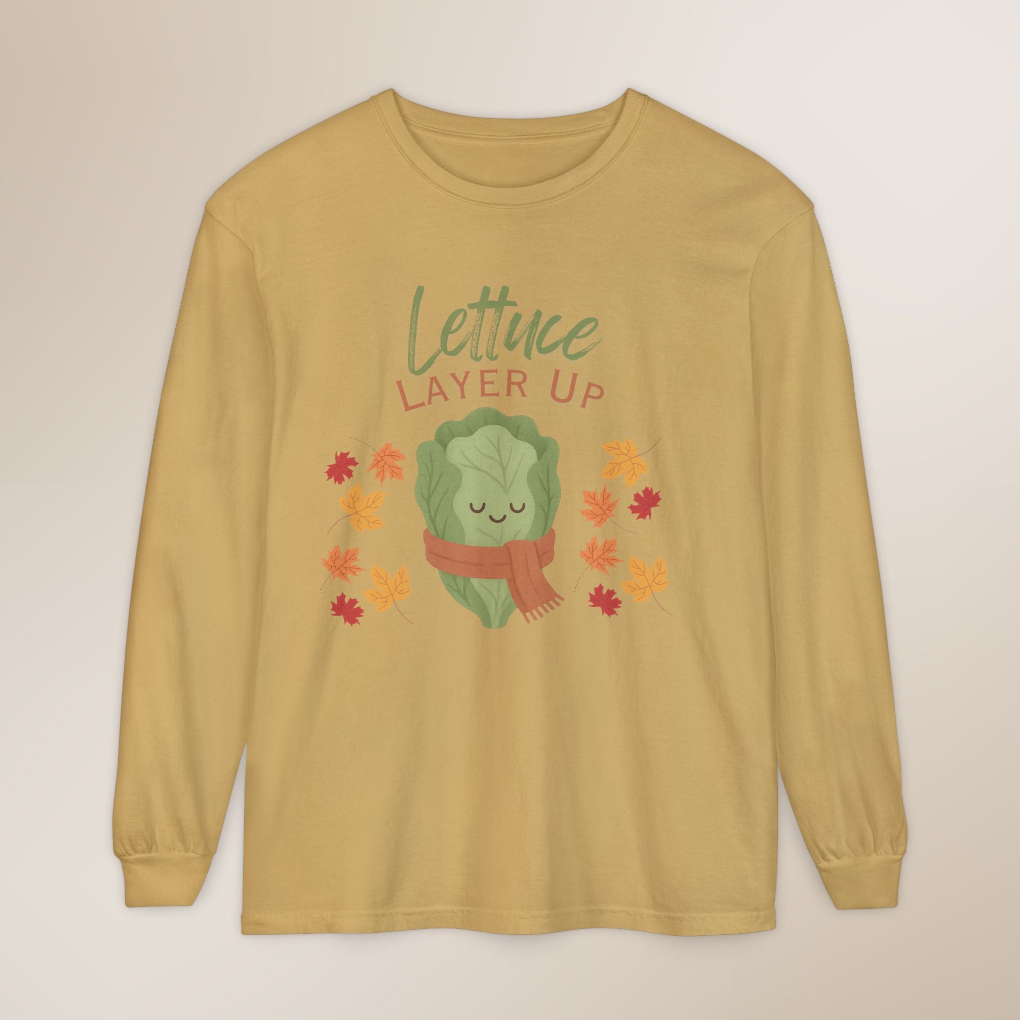 Yellow long-sleeve shirt with a lettuce graphic and 'Lettuce Layer Up' text on a beige background