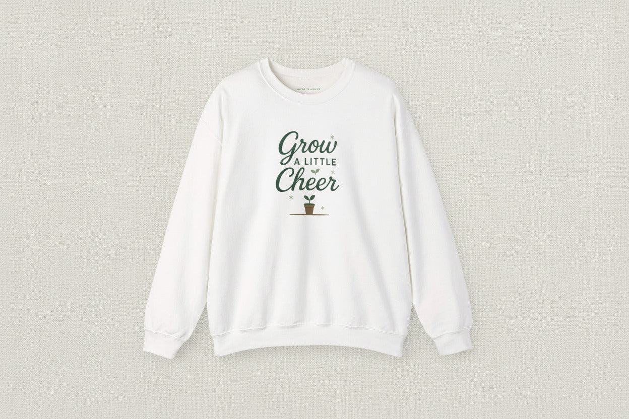 White sweatshirt with 'Grow a Little Cheer' text and plant graphic on a white background