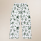 Pajama pants with green snowflake pattern on a beige background