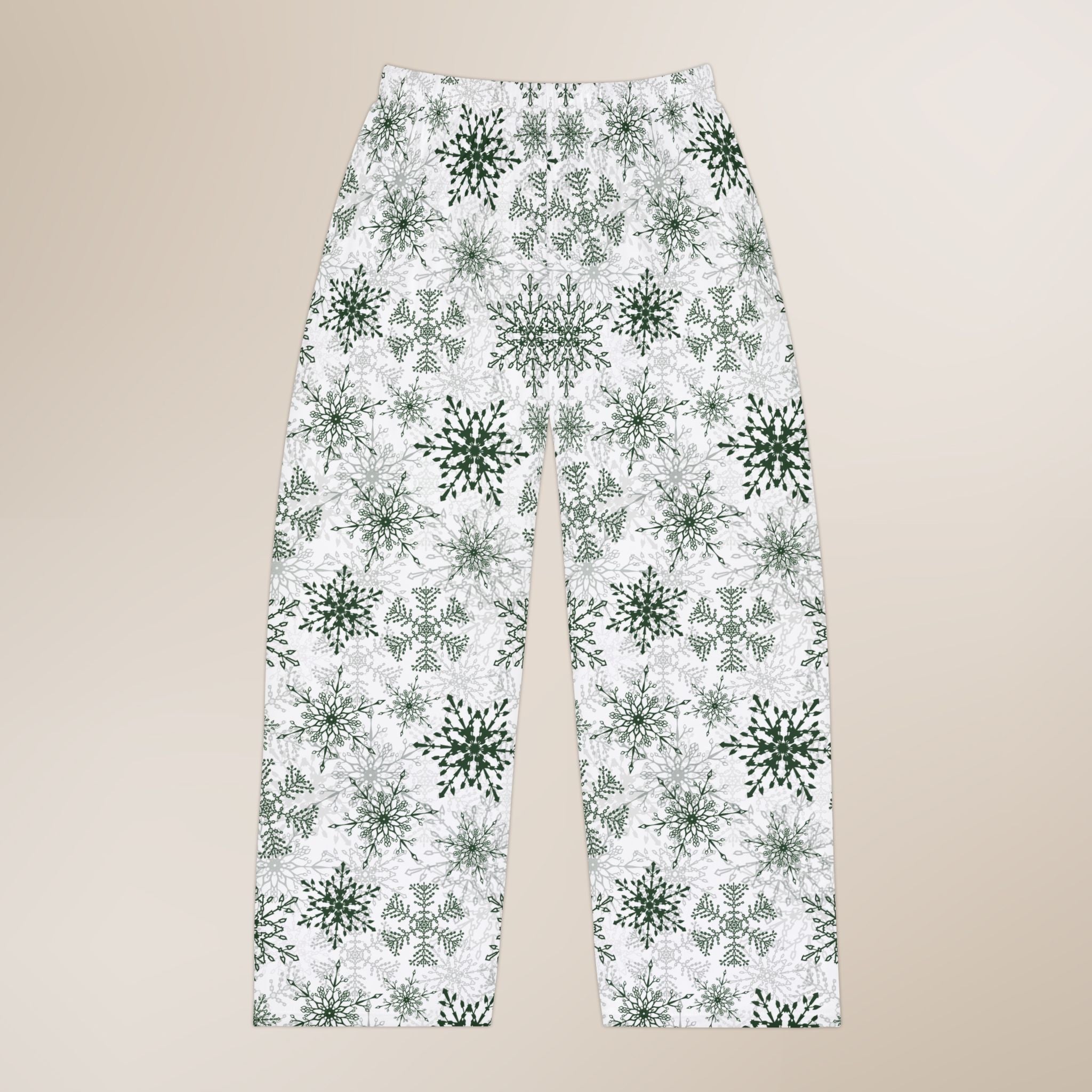 Pajama pants with green snowflake pattern on a beige background