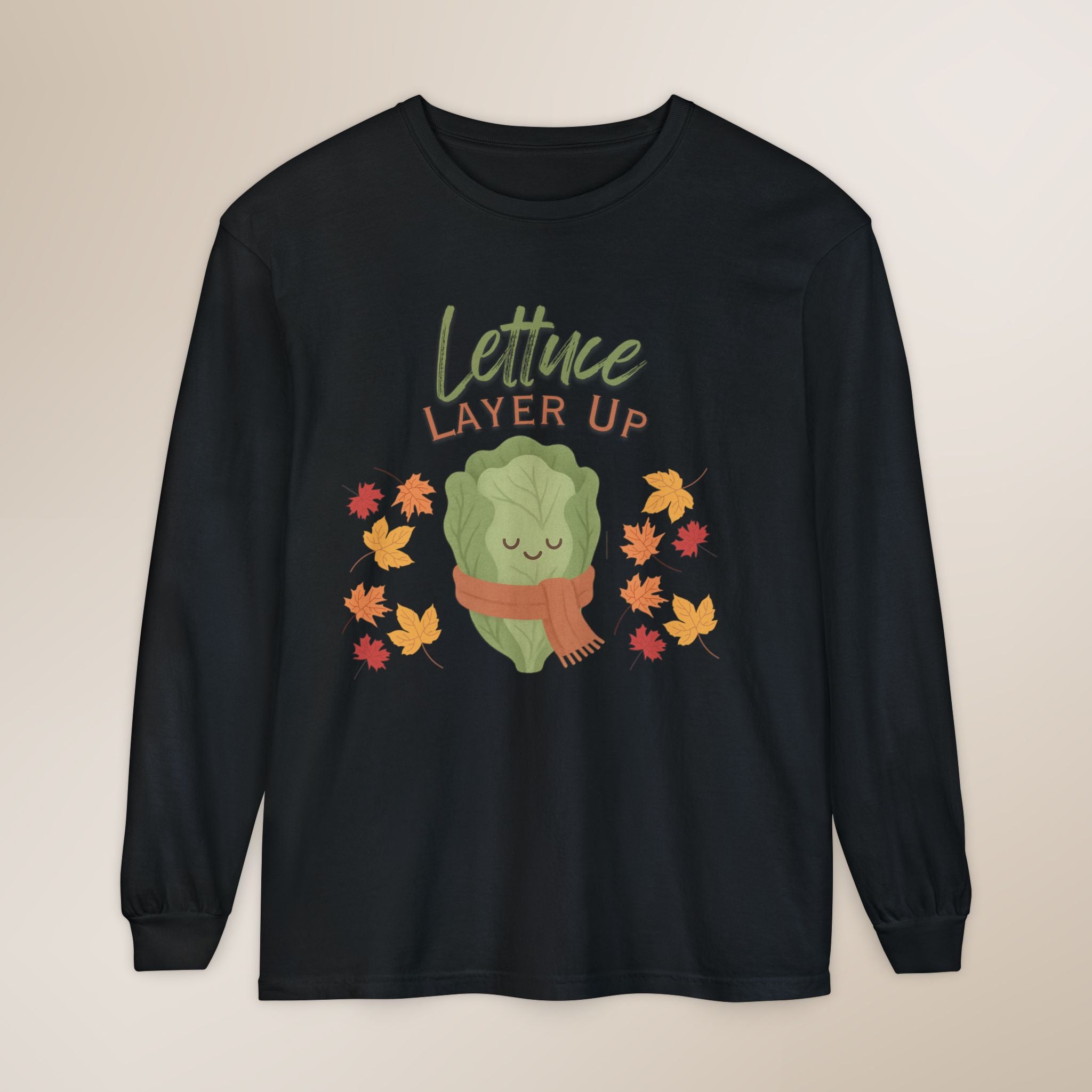 Black long-sleeve shirt with a cartoon lettuce character and 'Lettuce Layer Up' text on a beige background