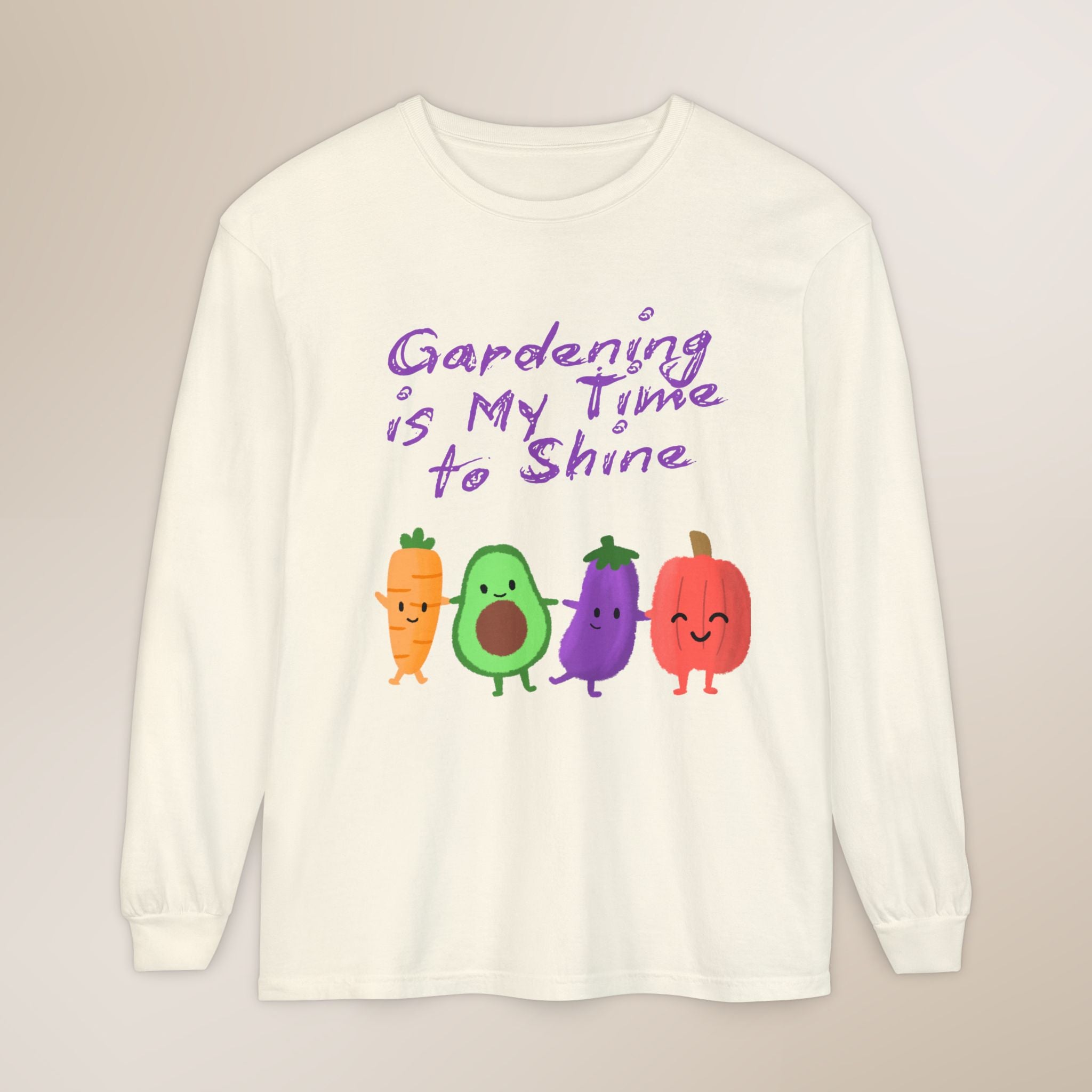 White long-sleeve shirt with cartoon vegetables and text 'Gardening is My Time to Shine' on a beige background
