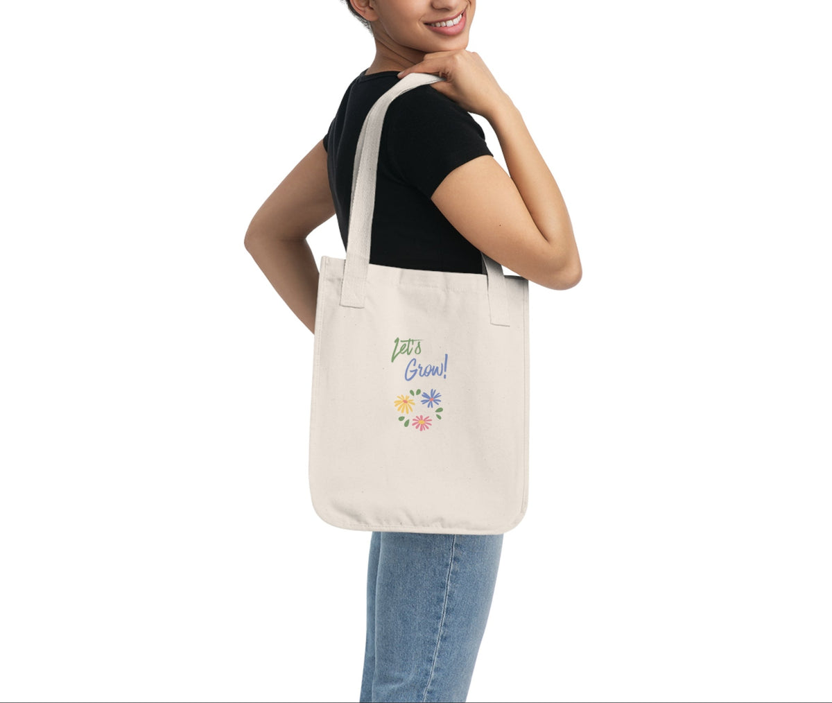 Woman holding a beige tote bag with a logo on a white background