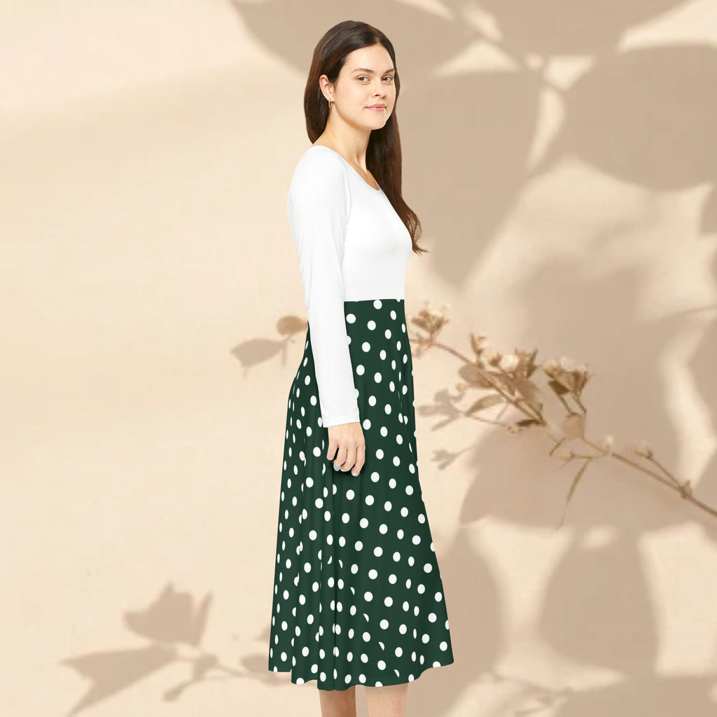 Woman wearing a white top and green polka dot skirt against a beige background