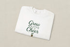 White sweatshirt with 'Grow a Little Cheer' text on a white background