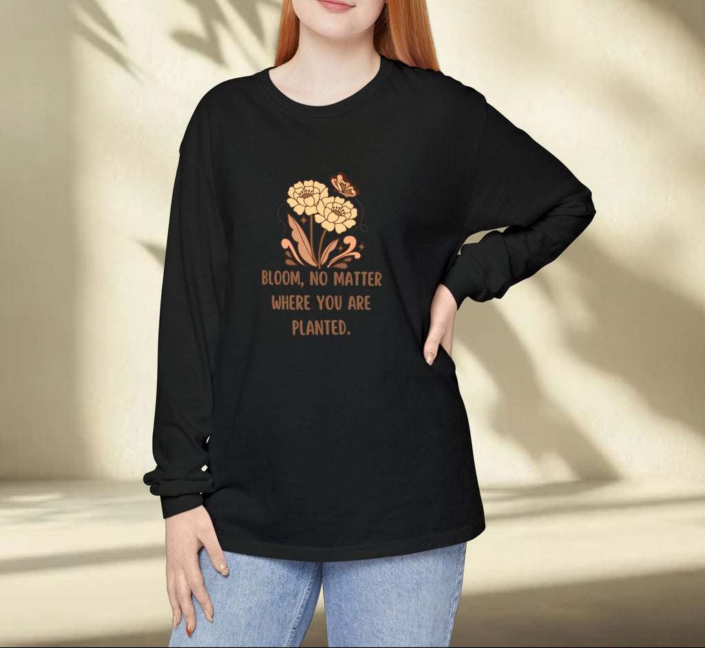 Person wearing a black sweatshirt with a floral design and text against a neutral background