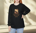 Person wearing a black sweatshirt with a floral design and text against a neutral background