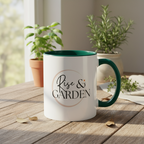 White mug with green interior and handle on a wooden table with plants in the background