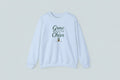 Light blue sweatshirt with 'Grow a Little Cheer' text on a white background