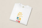 White t-shirt with 'The Best Gardener' text and floral designs on a beige background