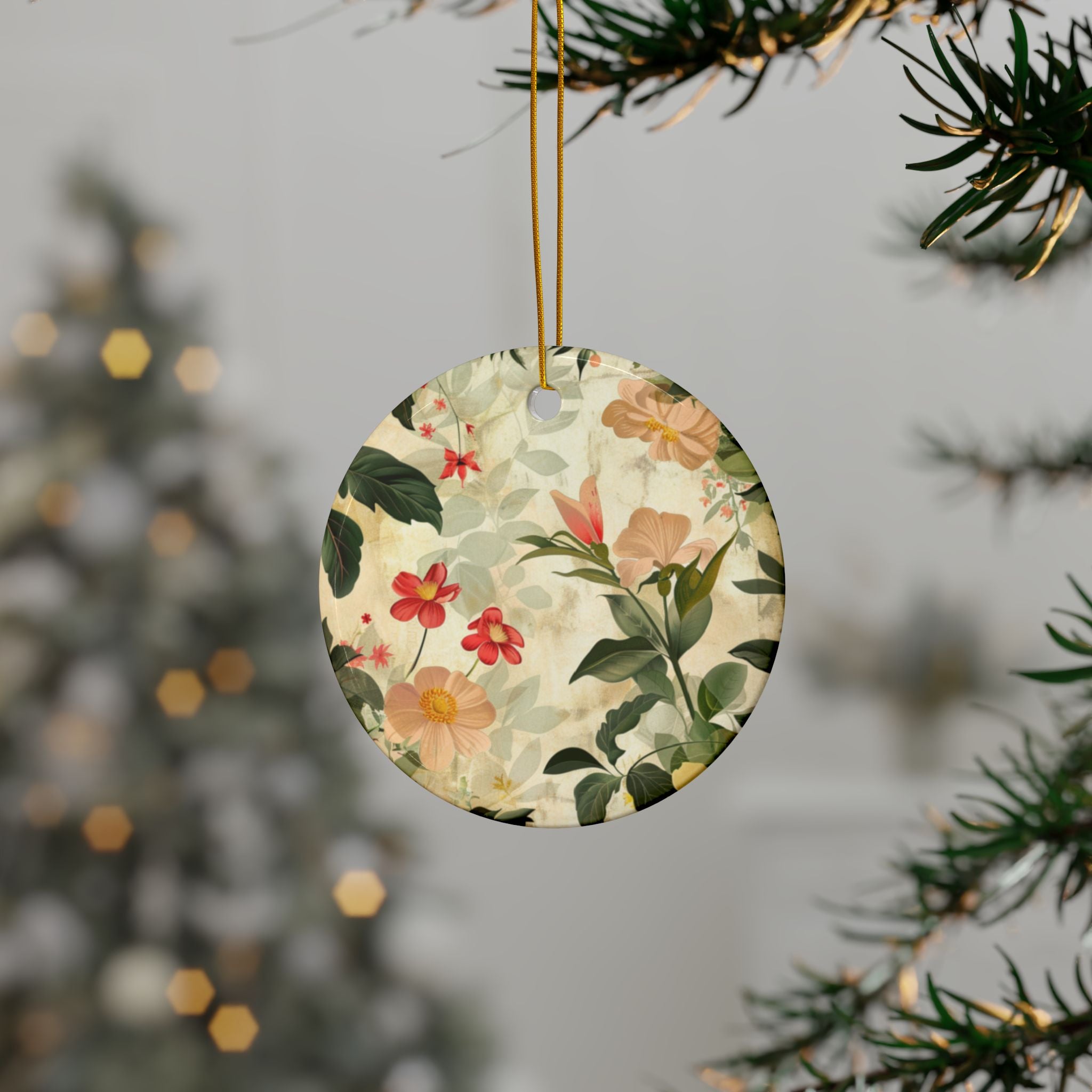 Round floral ornament hanging from a tree branch with a blurred festive background.