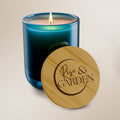 Blue candle with wooden lid featuring 'Rise & Garden' on a beige background