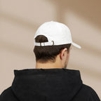 Person wearing a white cap and black hoodie from behind on a beige background