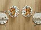 Four floral teacups with saucers on a wooden table.