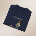 Navy blue t-shirt with 'Gardening' text and gardening-themed design on a beige background
