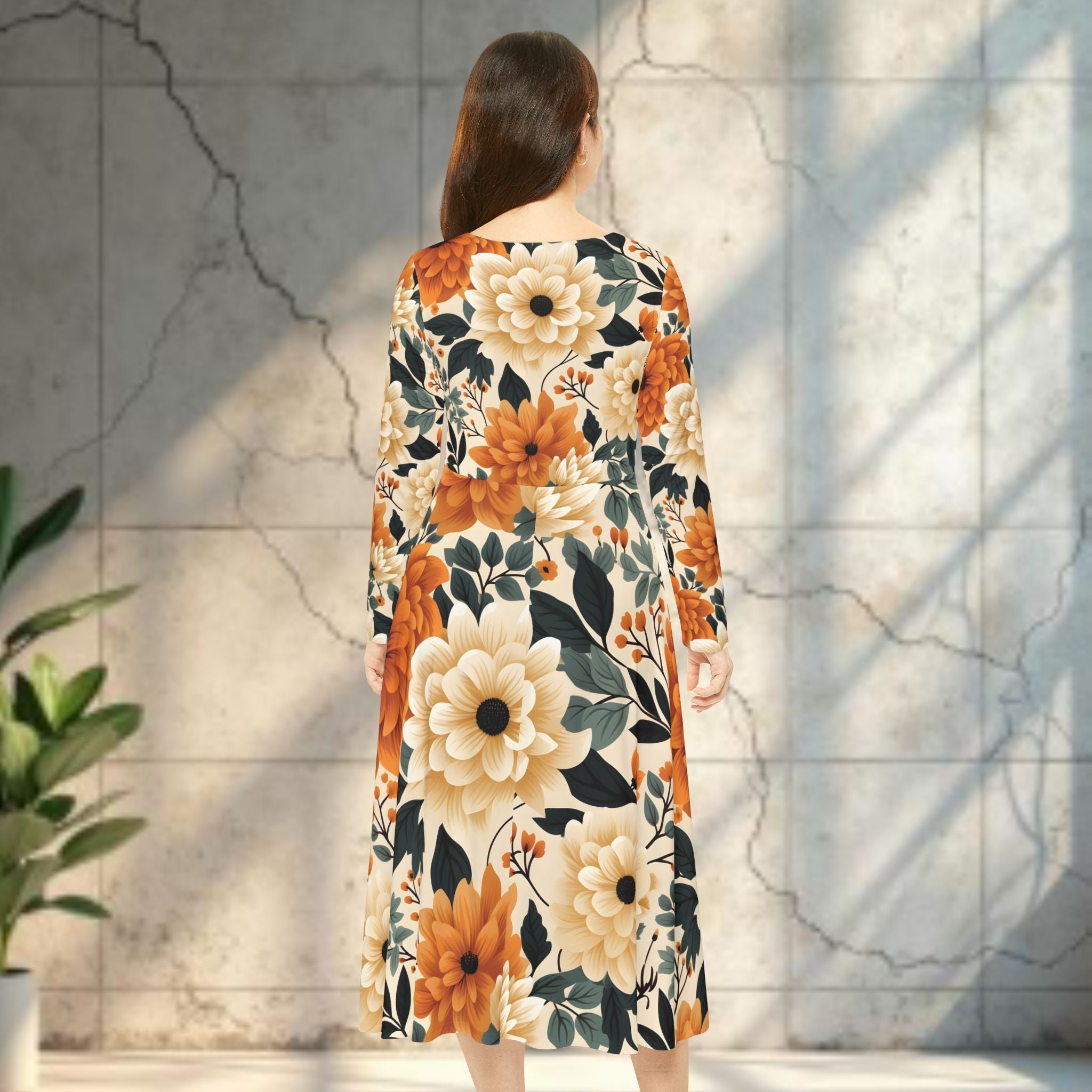 Woman wearing a floral dress with orange and beige flowers against a textured wall.