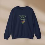 Navy blue sweatshirt with 'Gardening is My Therapy!' text and heart design on a beige background