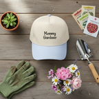 Gardening-themed items including a cap, gloves, flowers, and seeds on a wooden surface.