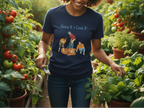 Person in a garden wearing a navy blue t-shirt with graphic design and text.