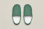 Pair of blue and black patterned slippers on a white background