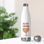 White water bottle with 'Fall into Gardening' design on a blurred green plant background