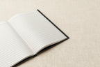 Open notebook with lined pages on a white background
