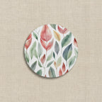 Round coaster with a colorful leaf pattern on a white background