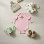 Pink baby onesie with 'Baby Gardener' text and carrot graphic on a white background