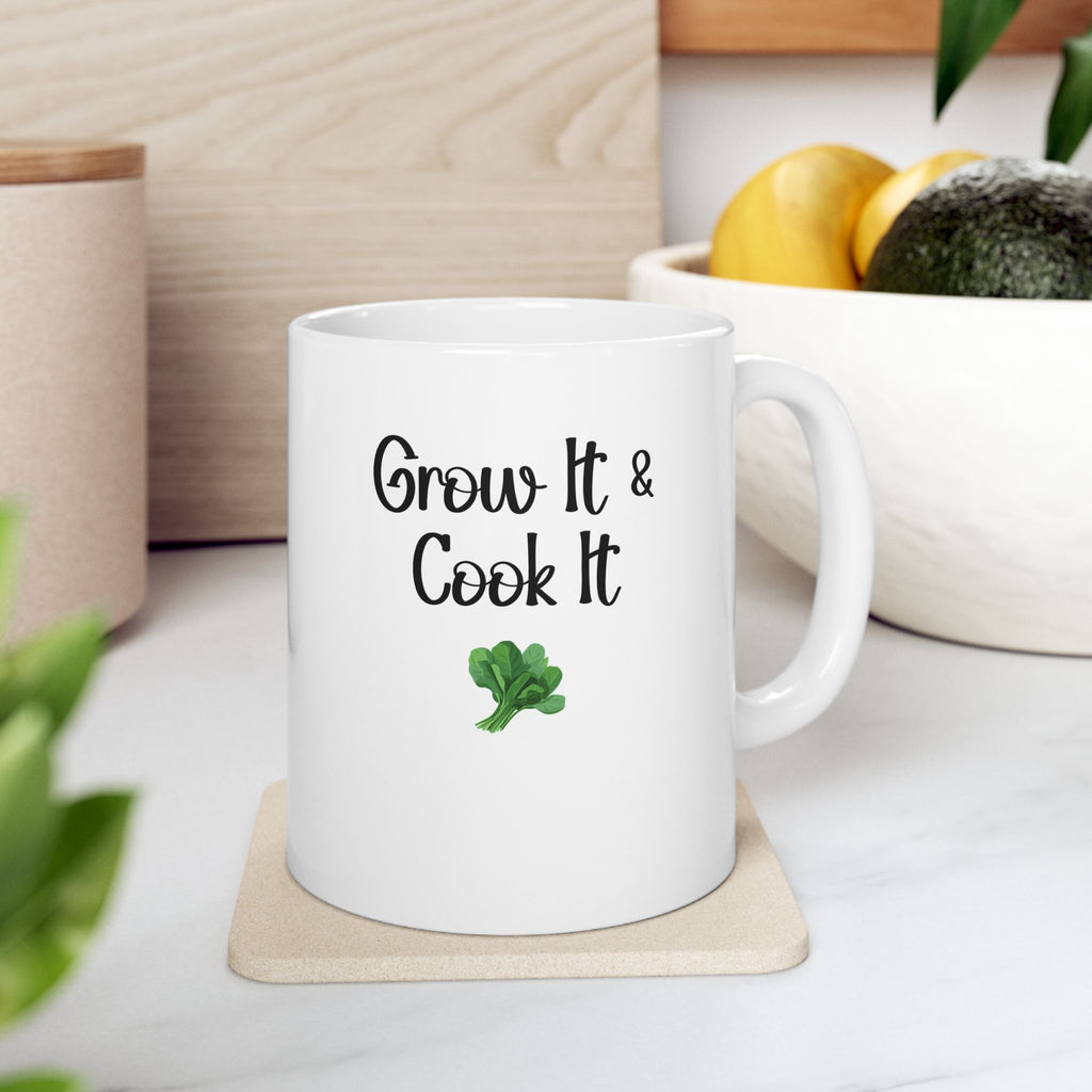 White mug with 'Grow It & Cook It' text and broccoli graphic on a wooden coaster.