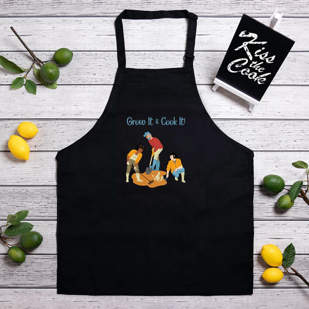 Black apron with graphic design on a wooden surface with lemons and limes.