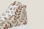 High-top sneaker with leaf pattern on a white background
