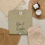 Folded olive green t-shirt with 'Rise & Garden' text on a neutral background
