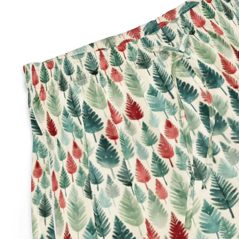 A close-up of a pleated skirt with an elastic waistband, featuring a watercolor-style print of palm leaves in shades of green, teal, and red on an off-white background.