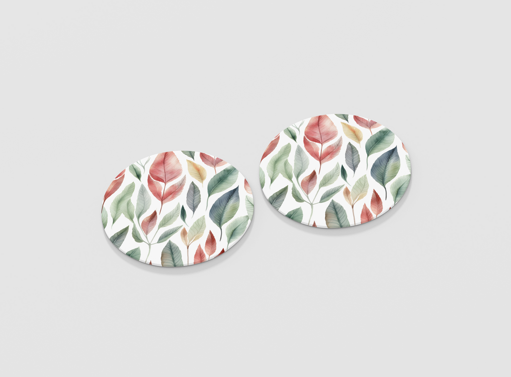 Pair of round earrings with leaf pattern on a light gray background