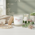 Candle labeled 'Gardening Peace' on a table with decorative items and plants.