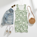 Floral dress with denim jacket, sneakers, sunglasses, and round bag on a white background