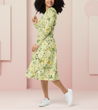 Woman wearing a floral dress against a pink background