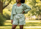 Woman in a green outfit standing in a park