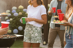 People at a barbecue party with drinks and food
