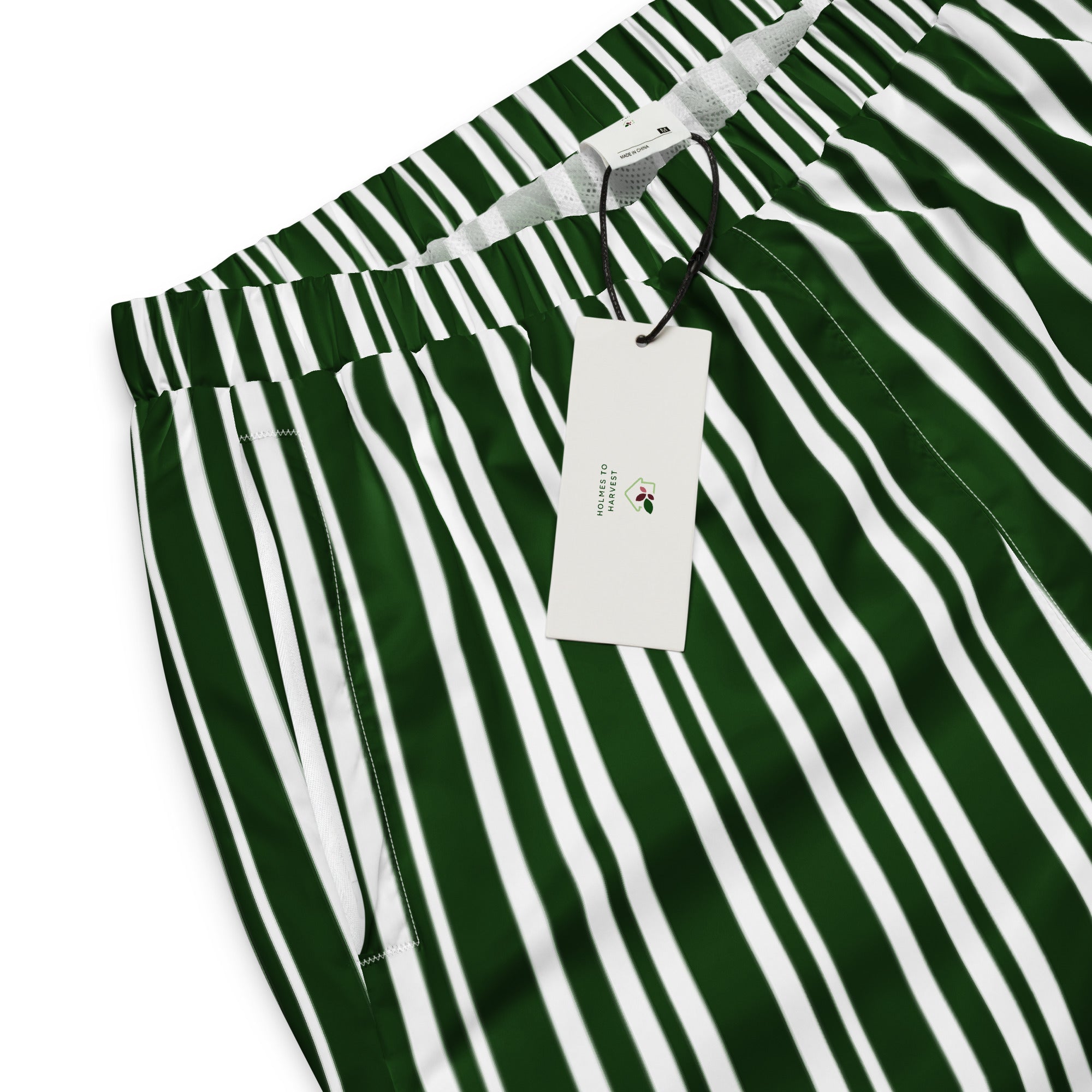Green and white striped pants with a tag on a white background