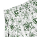 Green snowflake pajama shorts on white background
