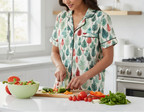 Person wearing a patterned pajama set in a kitchen preparing vegetables.