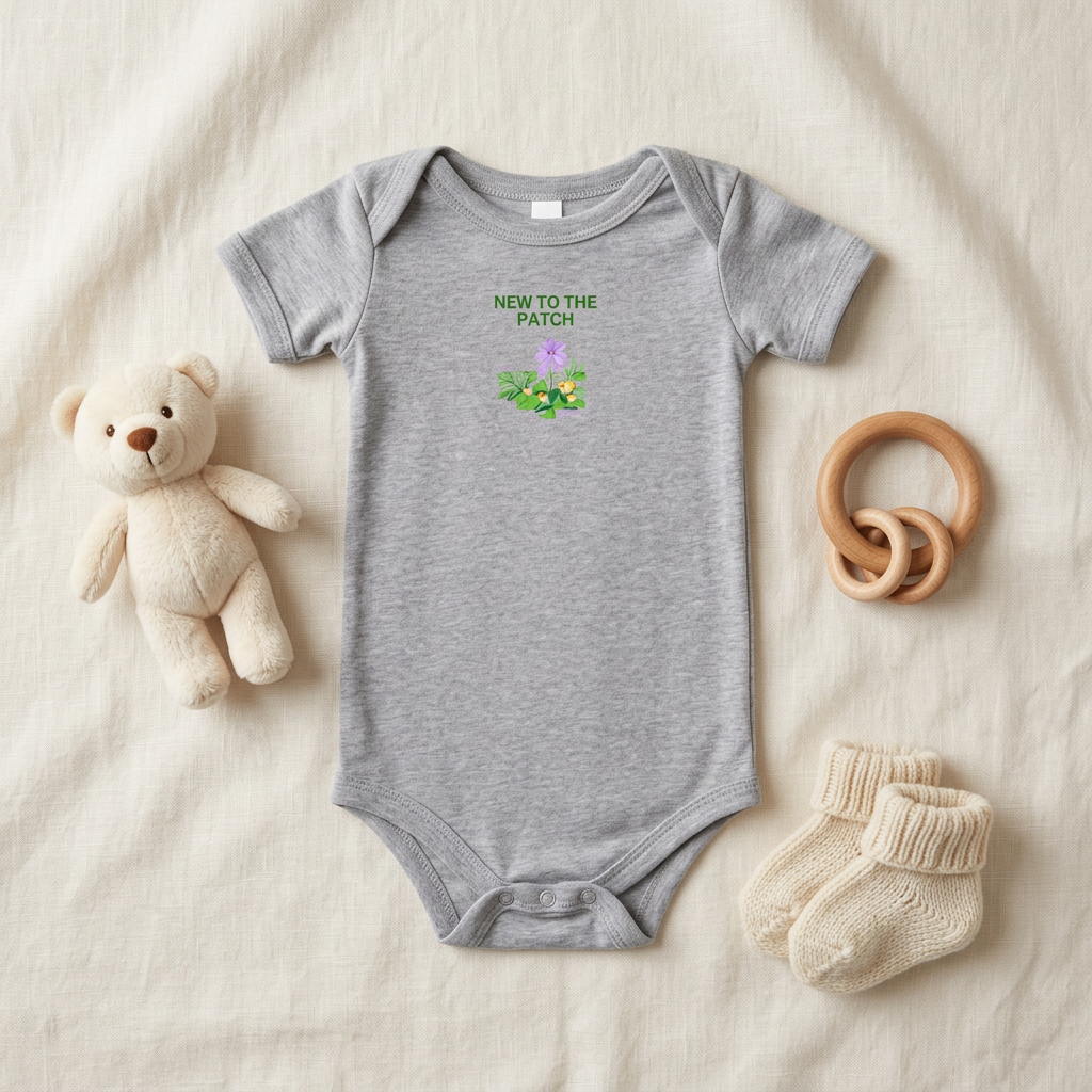 Gray New to the Patch flower baby onesie styled with baby accessories.