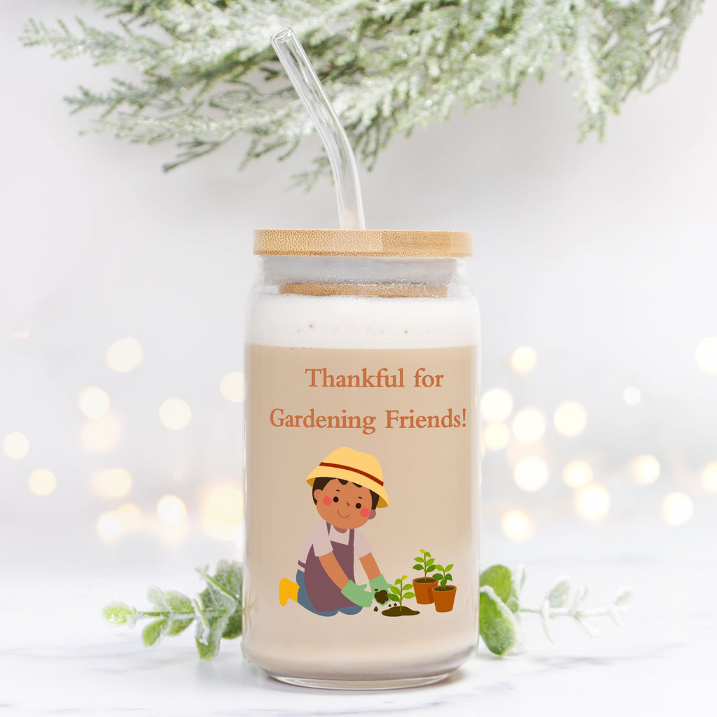 Jar with a straw, featuring a gardening-themed design and text, on a light background.