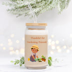 Jar with a straw, featuring a gardening-themed design and text, on a light background.