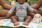 Baby girl in heather gray in a sunflower garden