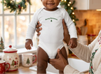 Baby girl in white by festive kitchen window
