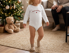 Blond toddler girl in white onesie